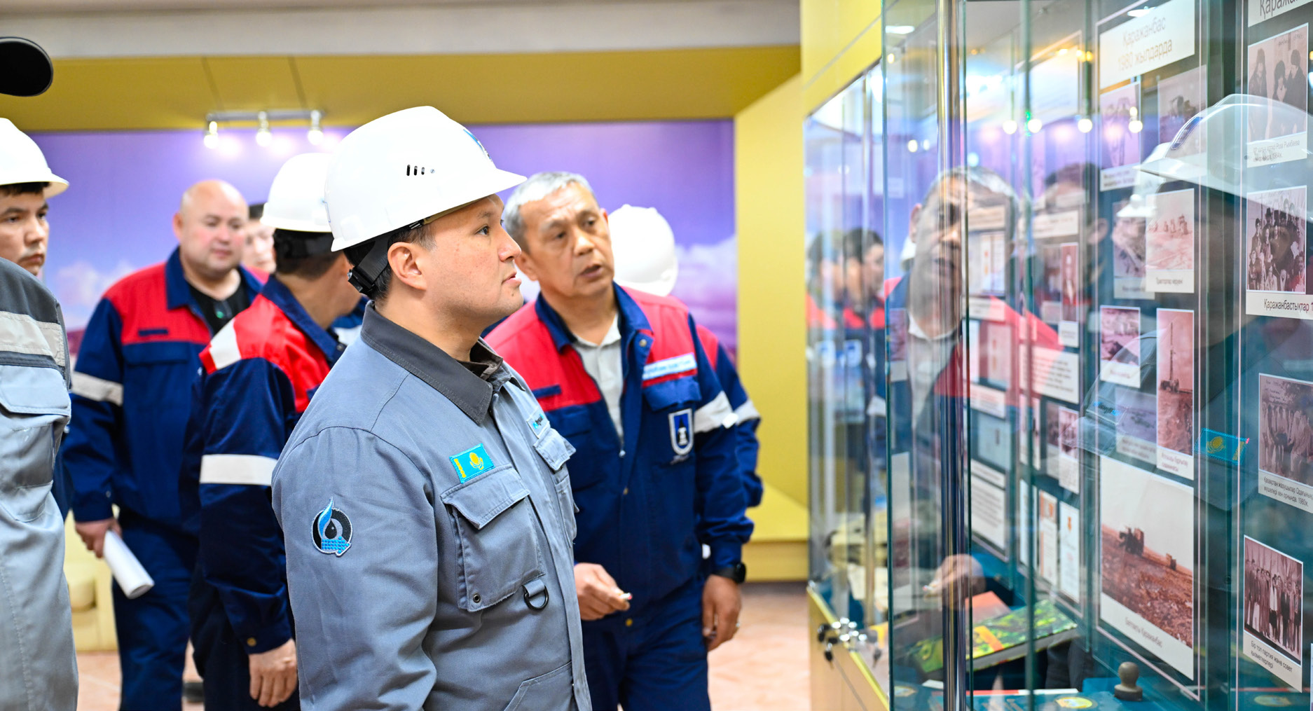 KMG employees reviewing a display at an industrial site